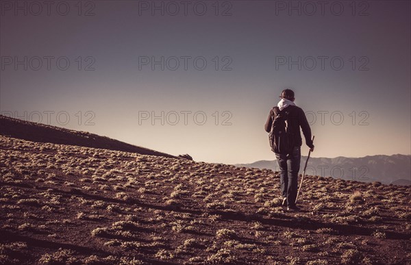 Hikers with backpacks and trekking poles walking in Turkish highland