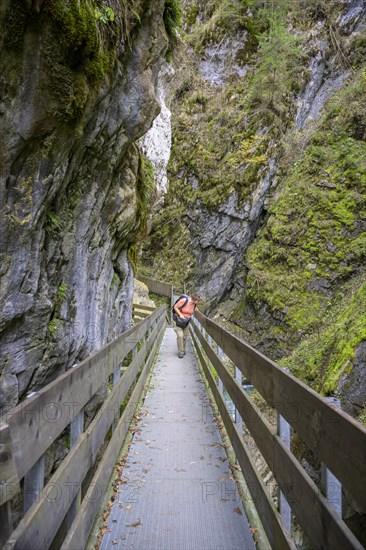 Hiker on a steep track in the Gilfenklamm