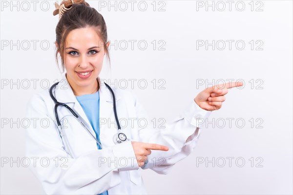 Portrait of smiling female doctor in medical gown standing isolated on white