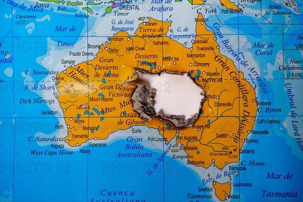 Close-up of a burned map of australia with ash residue in the copy space center