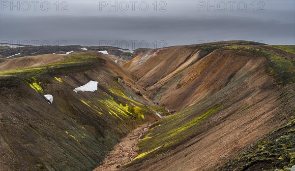 Small river between colourful rhyolite mountains