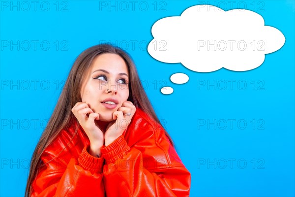 Thinking woman with many ideas with empty bubble on blue background
