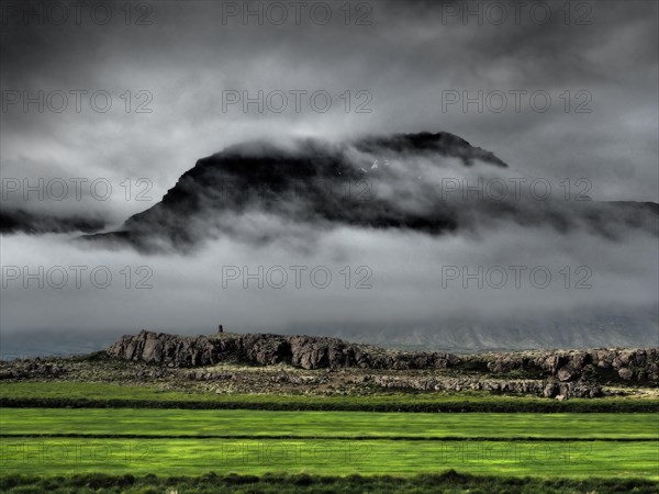 Fog drifts over mountainside