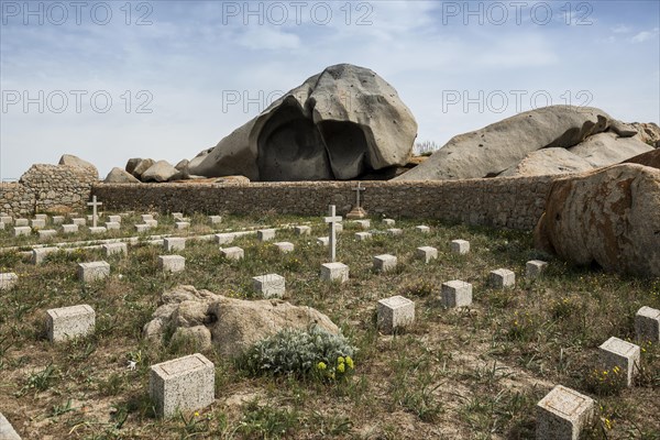 Granite rocks and cemetery on the beach