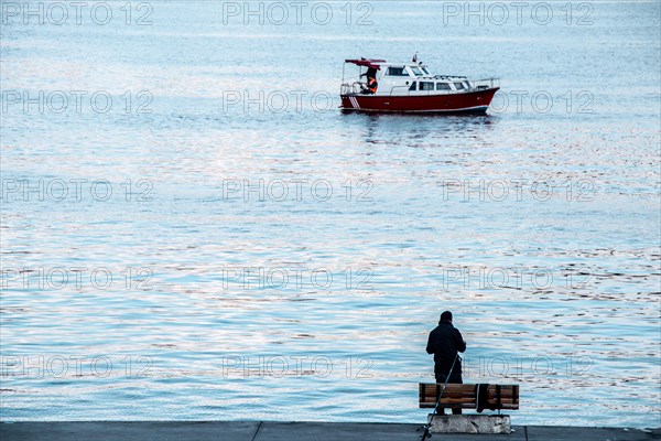 Fisherman by the sea fishing boat in the waters of the sea