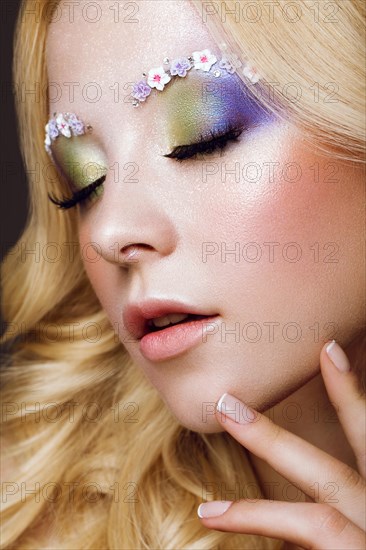 Beautiful young blonde woman with creative make-up color
