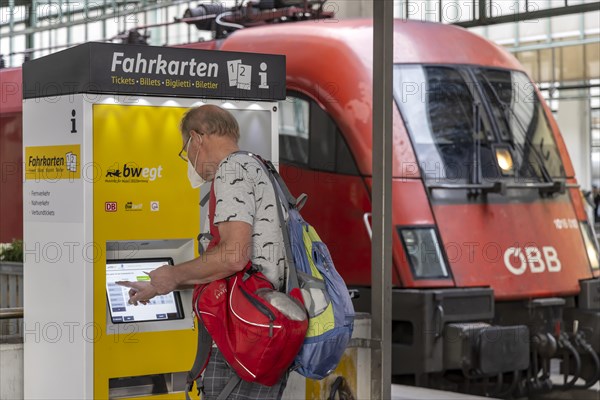 Passenger buys a ticket at the ticket machine