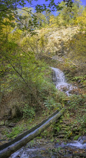 Wooden channel leads water from the Schnuggenbach waterfall into the Schenner Waalweg