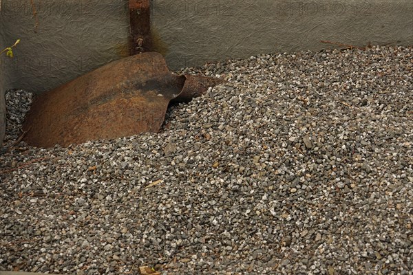 Rusty shovel and gravel