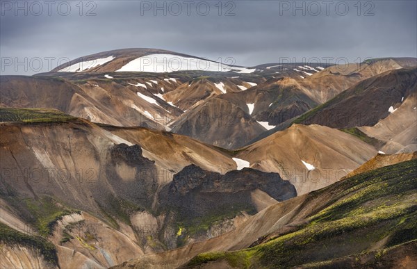 Colourful rhyolite mountains with remnants of snow