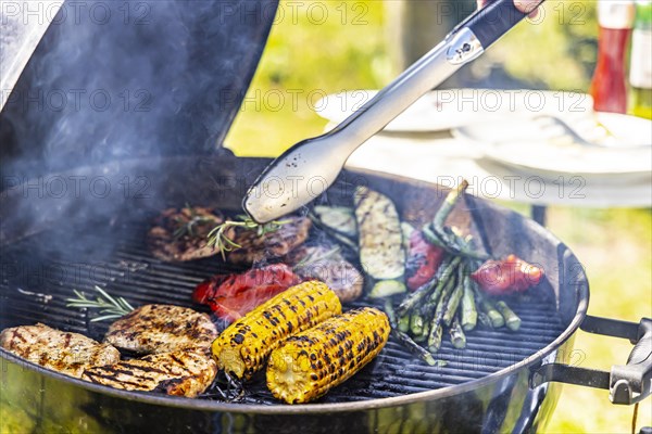 Charcoal grill in the garden with steaks and vegetarian barbecue