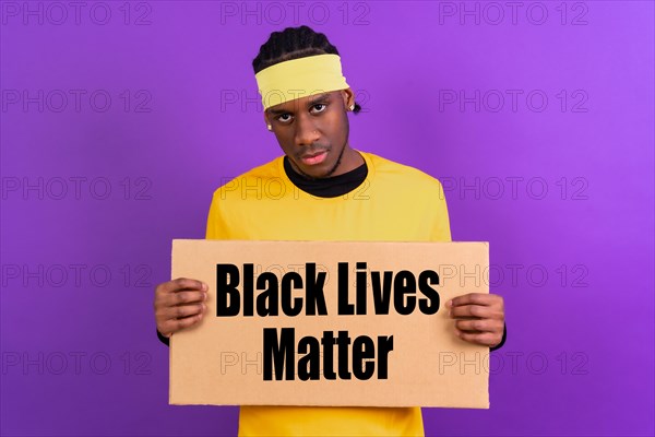 Black ethnic man in yellow clothes on a purple background