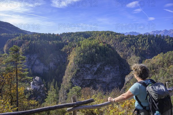 Hiker looks down to the former hermitage and place of pilgrimage