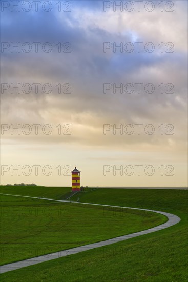 Pilsum lighthouse on the dyke near Greetsiel in the Krummhoern region on the East Frisian North Sea coast