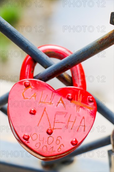 Colorful metal love padlock on fence