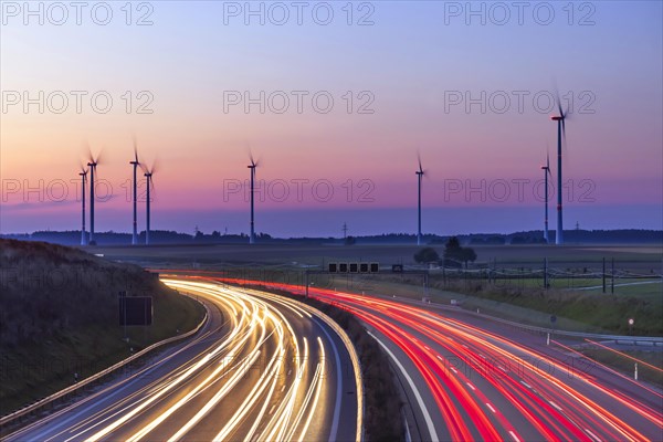 Wind farm with wind turbines in the Swabian Alb in front of sunrise