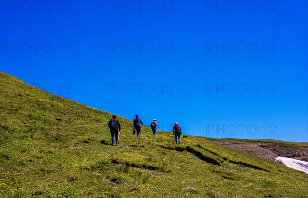 Hikers with backpacks and trekking poles walking in Turkish highland