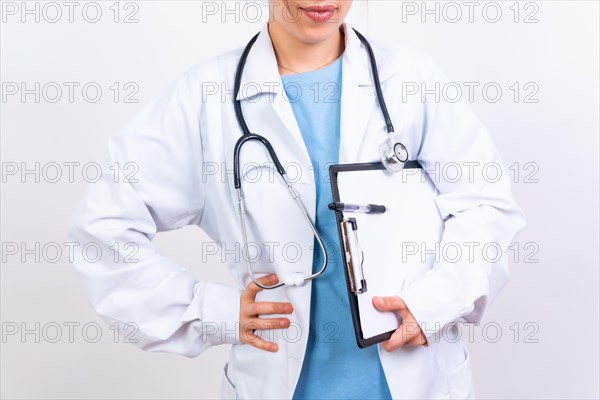 Happy beautiful female doctor in medical coat standing isolated on white