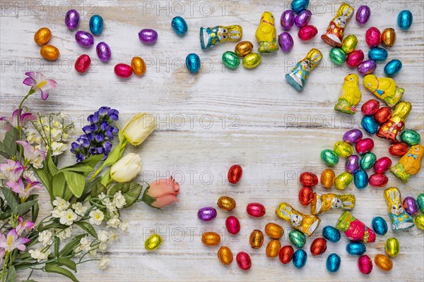 Frame of colourful Easter sweets on wood