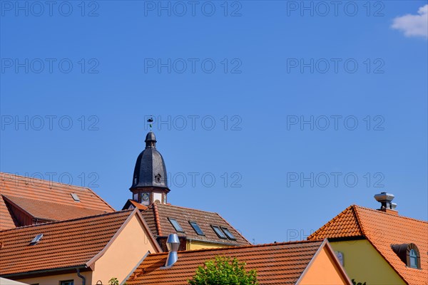 Roof structures and steeple of St. Mary's Church in the historic town centre of Waren an der Mueritz