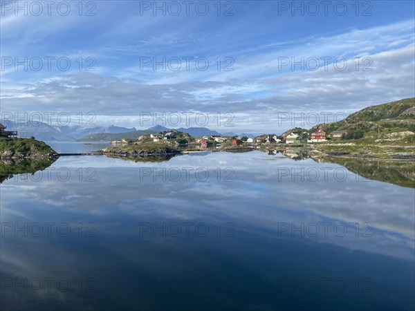Crystal clear water and wooden houses reflected in the water