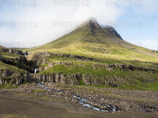 Fog drifts over lonely hills