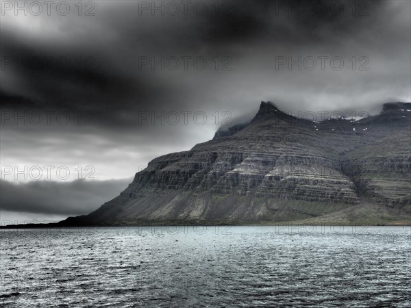 Fog drifts over mountainside