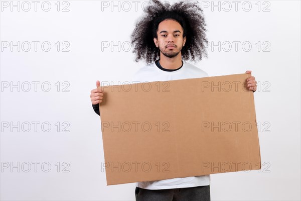 Holding a sign with copy paste space. Young man with afro hair on white background