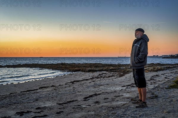 Old man standing on the coast of the Bay of Biscay