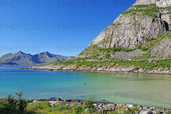 Crystal clear bay and fine sandy beach with single rocks