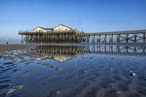 Morning atmosphere on the beach of Sankt Peter-Ording with pile dwellings