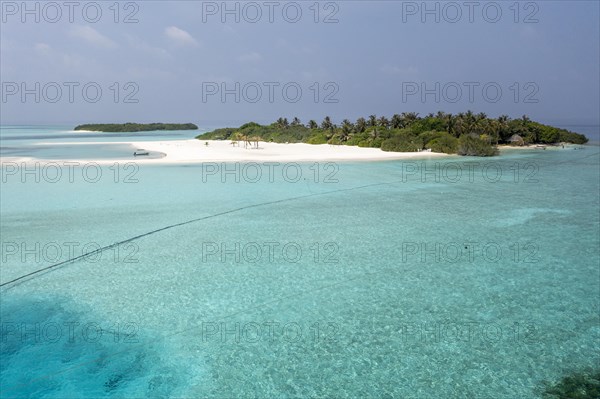 Aerial view: lonely Island with a sandbank and Palmtrees in the Maldives