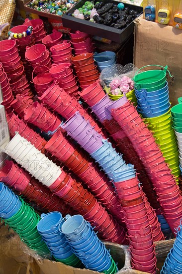 Little set of buckets of various colors in a market place