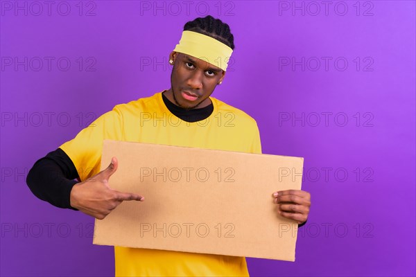Black ethnic man in yellow clothes on a purple background