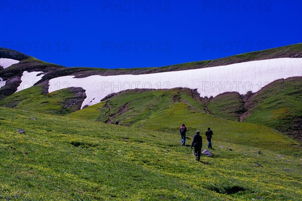 Hikers with backpacks and trekking poles walking in Turkish highland