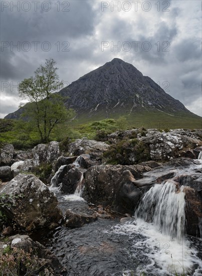 Waterfalls in front of mountain range Buachaille Etive Mor