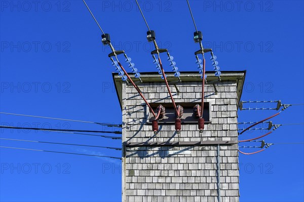 Transformer tower with wooden shingles and ceramic insulators