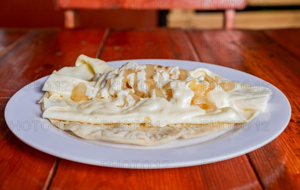 Plate of delicious Quesillo with pickled onion served on the table