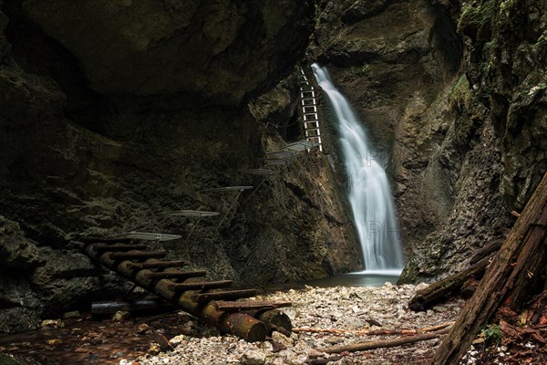 Difficul trail with ladder near the waterfall in canyon of National park Slovak paradise