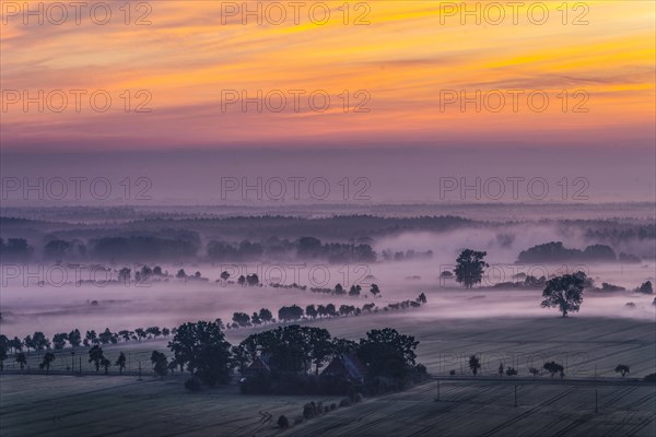 View from the Kniepenberg lookout tower of sunrise and morning fog in the Lower Saxony Elbe floodplain near Neu Darchau