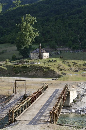 Small mosque and cemetery with bridge over the river Valbona