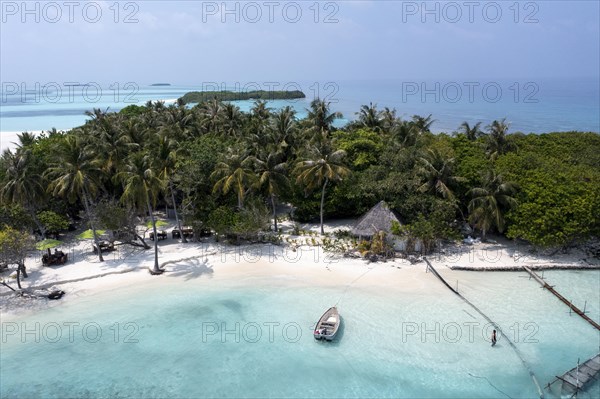 Aerial view: lonely Island with a sandbank and Palmtrees in the Maldives