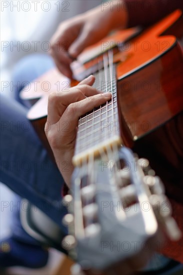 Close-up of a mans hands playing the spanish guitar selective approach