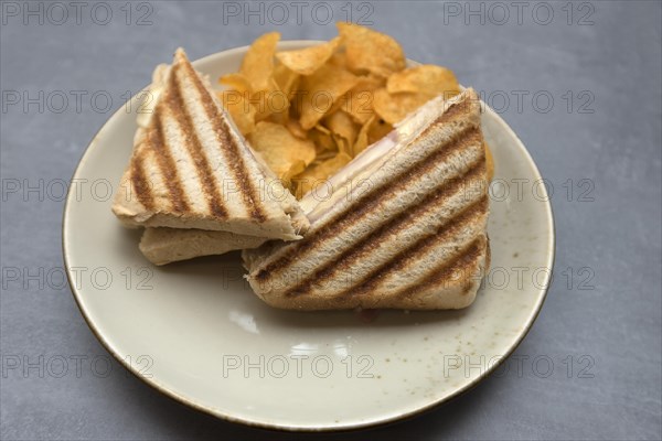 Ham and cheese toast served with chips