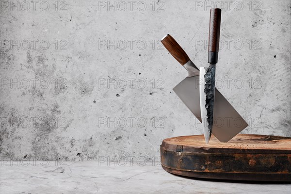 Knive and cleaver sticking out of wooden stump