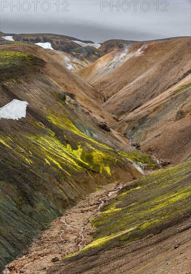 Small river between colourful rhyolite mountains