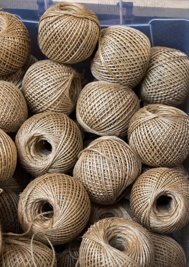 Plenty of spools or rolls of brown color linen string