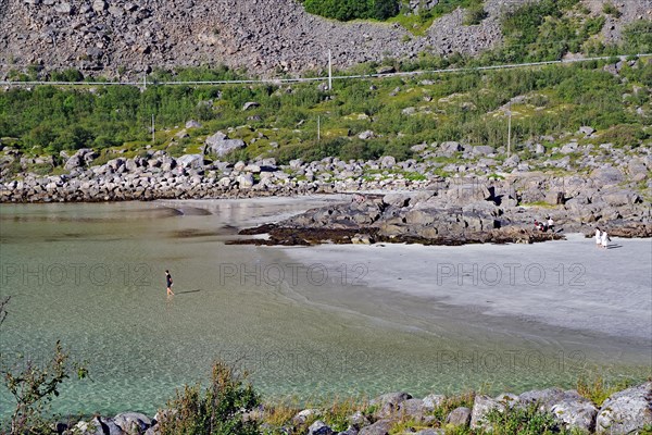 Crystal clear bay and fine sandy beach with single rocks