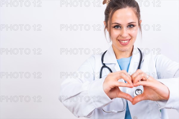 Portrait of smiling female doctor in medical gown standing isolated on white