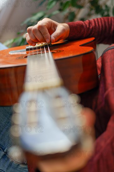 Close-up of a mans hands playing the spanish guitar selective focus